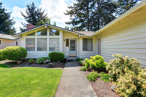 istock American house with siding trim and well kept lawn around. 594063676