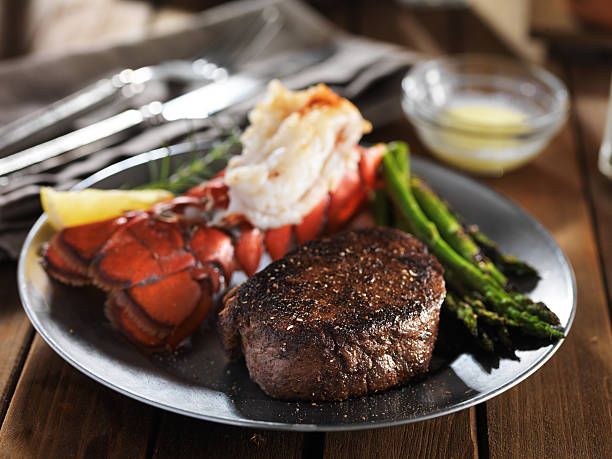 istock steak and lobster surf & turf gourmet dinner with asparagus 594065288