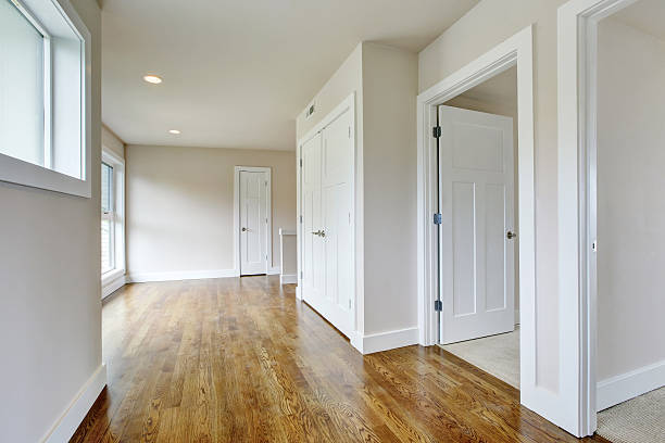 istock Empty hallway interior in white tones with hardwood floor 594066566