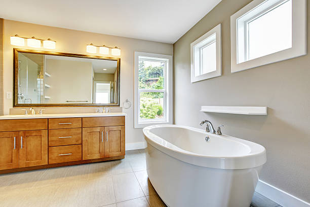 istock Bathroon interior with vanity cabinet, two sinks and bath tub. 594067544
