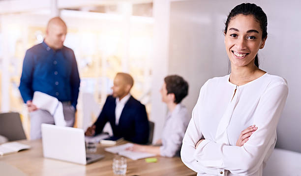 istock confident young smiling business woman representing her multiethnic team 594068592