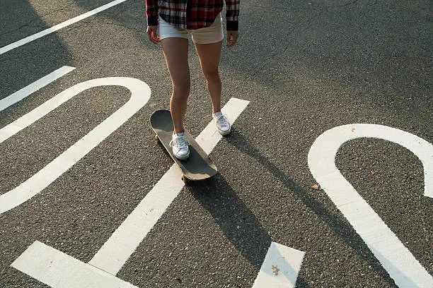 Photo of Women to skate board on the street.