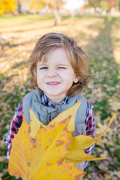 istock Autumn boy winking towards the camera. 594075022