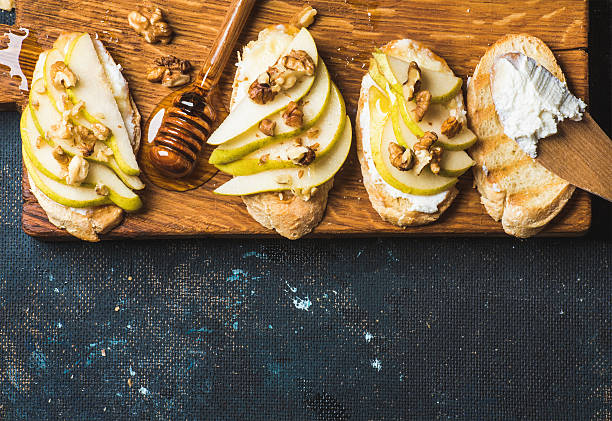 istock Crostini with pear, ricotta cheese, honey and walnuts 594075176