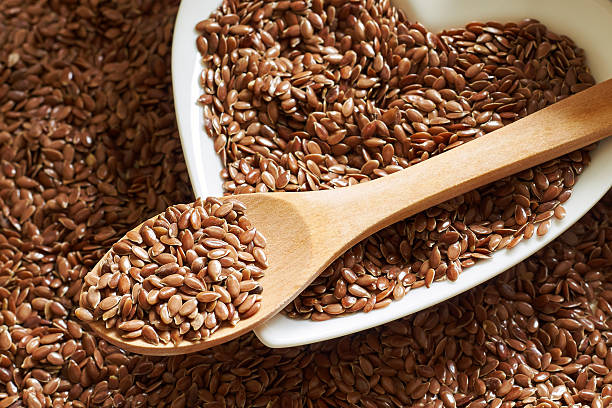 istock Flax seeds in wooden spoon 594078130
