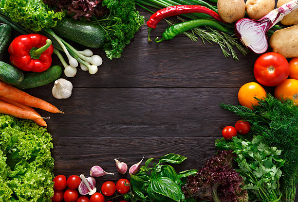 istock Frame of fresh vegetables on wooden background with copy space 594078510