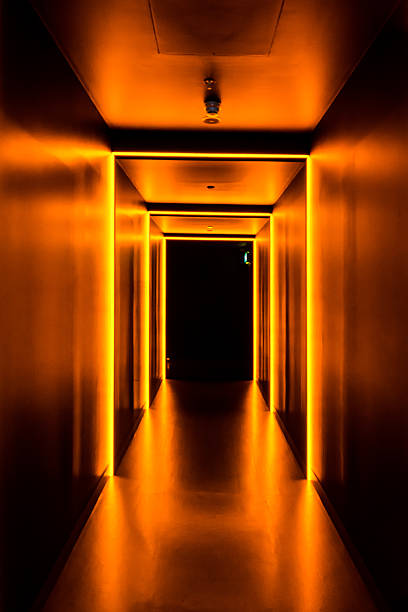 istock Dramatic Neon Orange Hallway into Darkness Mysterious 594078526