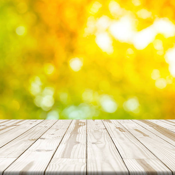 istock Wood table top on shinny bokeh in background 594079448