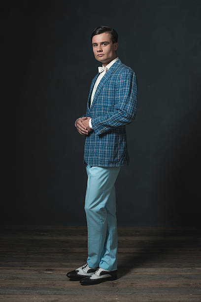 istock Young man wearing retro 1920s checkered jacket with bow tie. 594444716