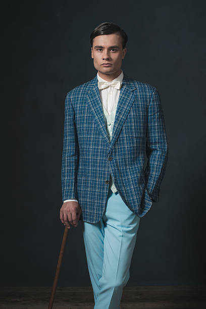 istock Vintage 1920s well dressed young man standing with cane. 594445010