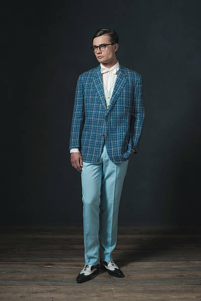 istock Retro 1920s dandy man wearing blue checkered jacket and pants. 594445220