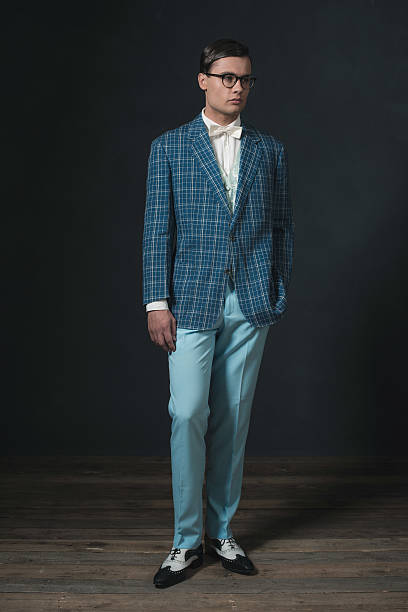 istock Retro 1920s dandy man wearing blue checkered jacket and pants. 594445286
