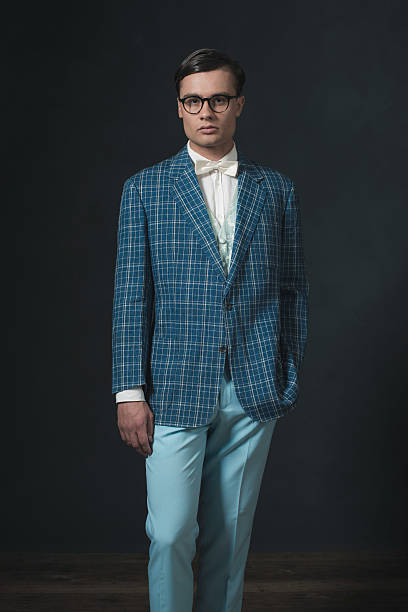 istock Retro 1920s dandy man wearing blue checkered jacket and pants. 594445308
