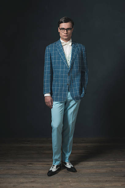 istock Retro 1920s dandy man wearing blue checkered jacket and pants. 594445336