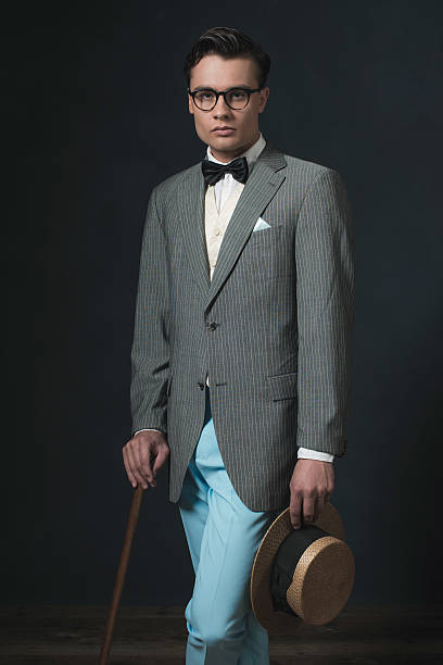istock Retro 1920s business man with hat and cane. 594445404