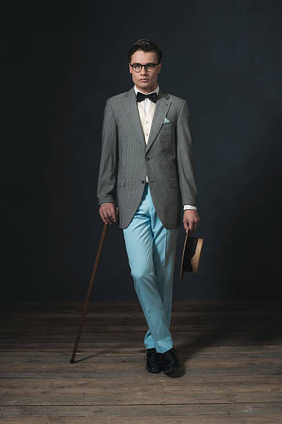 istock Retro 1920s business man with hat and cane. 594445494