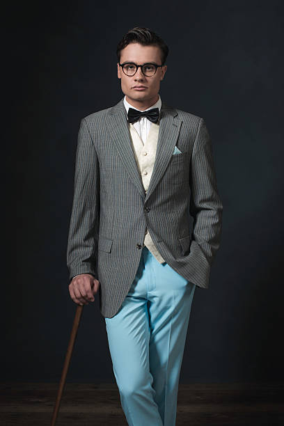 istock Retro 1920s man in suit with glasses and cane. 594445536