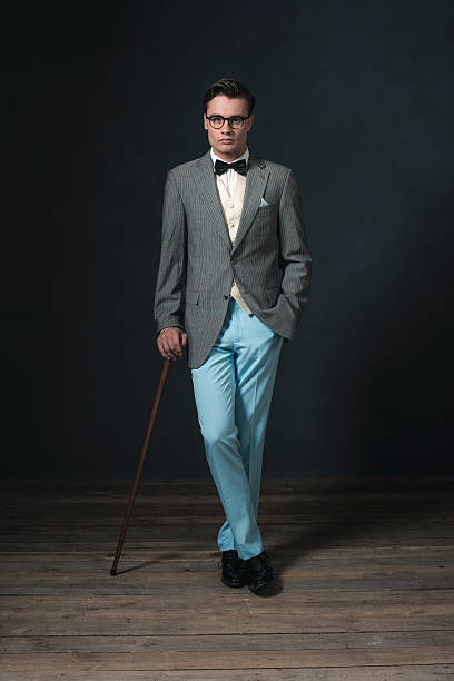 istock Retro 1920s man in suit with glasses and cane. 594445560
