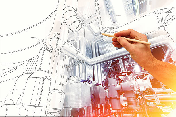man's hand draws a design of factory