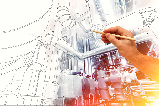 man's hand draws a design of factory combined with photo of modern industrial power plant