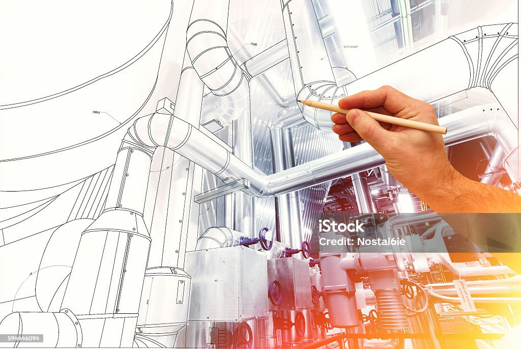 man's hand draws a design of factory man's hand draws a design of factory combined with photo of modern industrial power plant Engineer Stock Photo