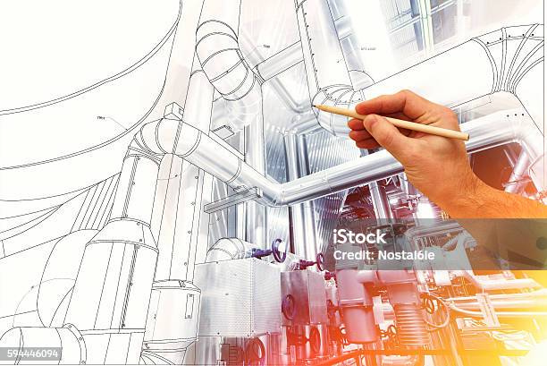 Mans Hand Draws A Design Of Factory Stock Photo - Download Image Now - Engineer, Engineering, Backgrounds