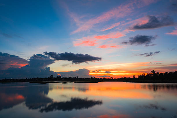 istock Reflection sky and clouds over lake with beautiful sunset 594446118