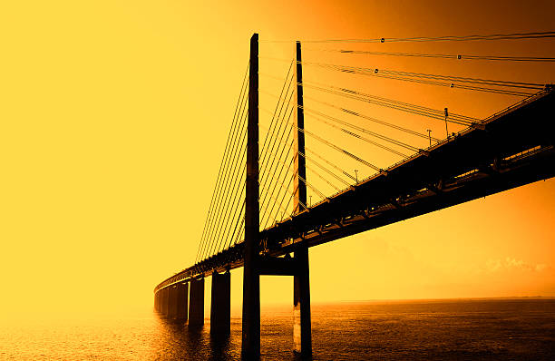 The Bridge - Die Brücke The Oresund bridge between Sweden and denmark - Die Öresundbrücke bei Gegenlicht zwischen Schweden und Dänemark oresund bridge stock pictures, royalty-free photos & images