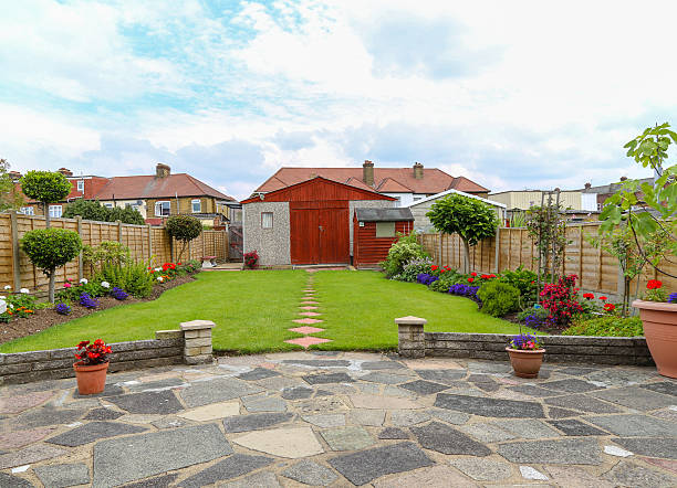 istock Suburban semi-detatched garden with garage 594447574