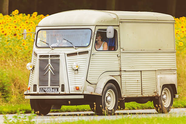 Vintage Citroen HY in front of a field with sunflowers Dieren, The Netherlands - August 14, 2016: Retro styled image of a Vintage Citroen HY on a local road in front of a field with blooming sunflowers in Dieren, The Netherlands citroen hy stock pictures, royalty-free photos & images
