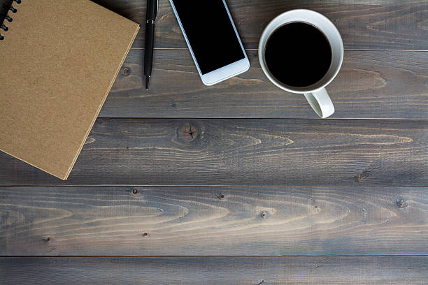 istock work desk wood table with office supplies 594447982