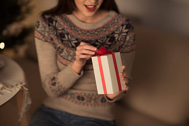 istock Woman opening Christmas gift 594448002