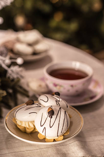 istock Tea and cakes on table in front of Christmas Tree 594448118