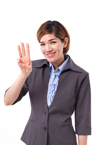 istock business woman pointing up three finger 594449110