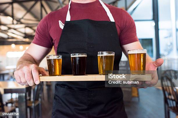 Waiter Holding A Tray Of Beer Tasting Glasses Stock Photo - Download Image Now - Exploration, Brewery, Craft Beer