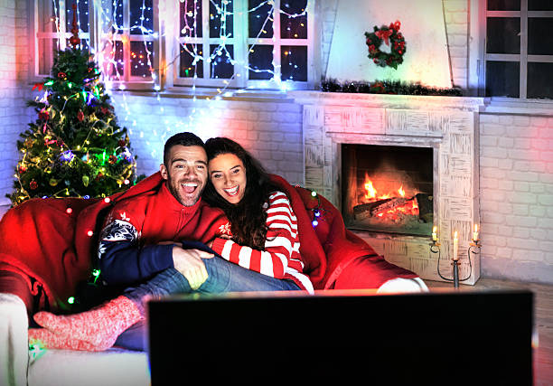 istock Happy couple watching TV at home 594450254