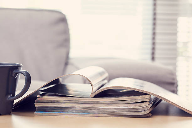 istock Reading magazine in living room 594450878