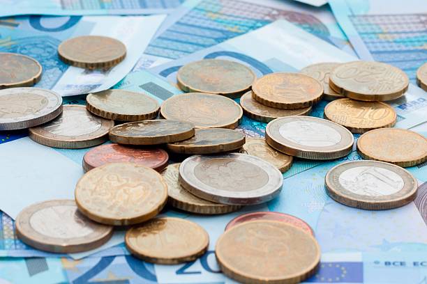 istock Euro banknotes and coins 594451330