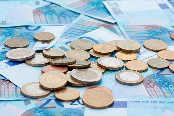 istock Euro banknotes and coins 594451368