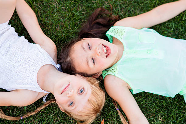 istock Two little sisters having fun in summer park 594451700
