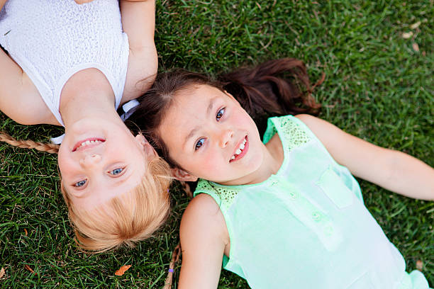 istock Two little sisters having fun in summer park 594451768