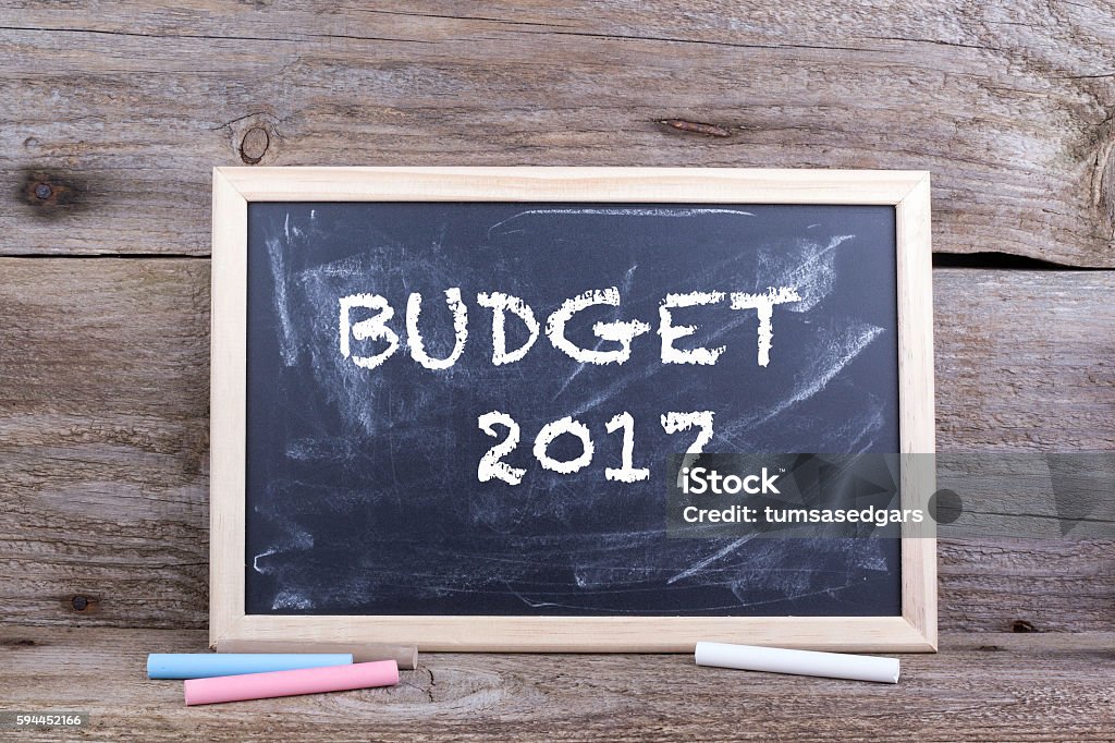 Budget 2017 Budget 2017. Old wooden background with texture and chalk blackboard 2017 Stock Photo