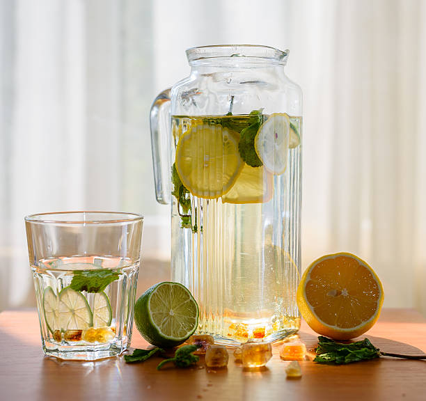 istock Pitcher of homemade lemonade with glass. 594452298