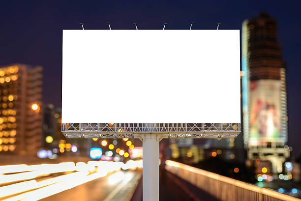 istock Blank billboard near expressway at night for advertisement. 594452442
