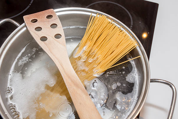 Cooking spaghetti with induction Spaghetti, Cooking, Cooking Pan, Saucepan, Pasta, induction, water, salt, boiling, container, dish, kitchen, food, eat electromagnetic induction stock pictures, royalty-free photos & images