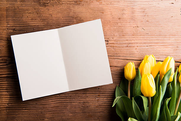 istock Bouquet of yellow tulips and empty greeting card 594455408