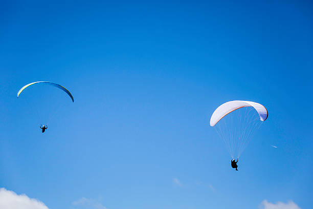 istock paragliding in the cloudy sky 594455636