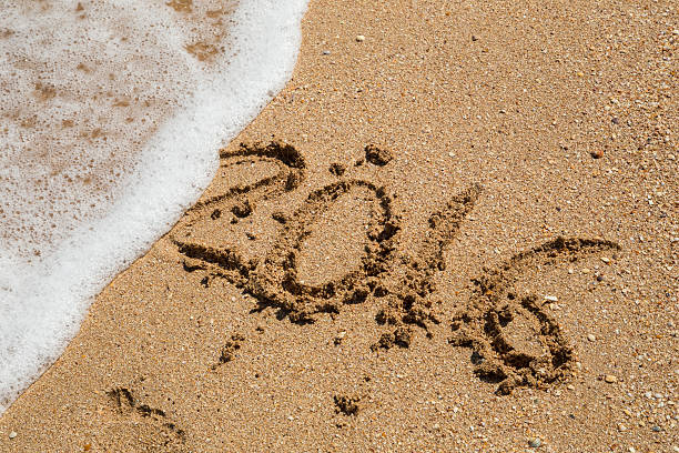 istock Sea wave wash away written 2016 year 594456458