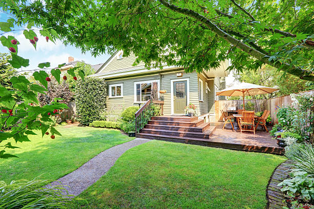 istock Backyard area with walkout deck and well kept lawn. 594456646