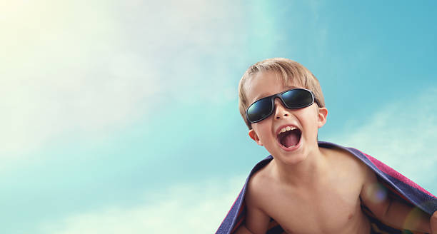 istock Boy wrapped in beach towel in summer sunshine 594457176